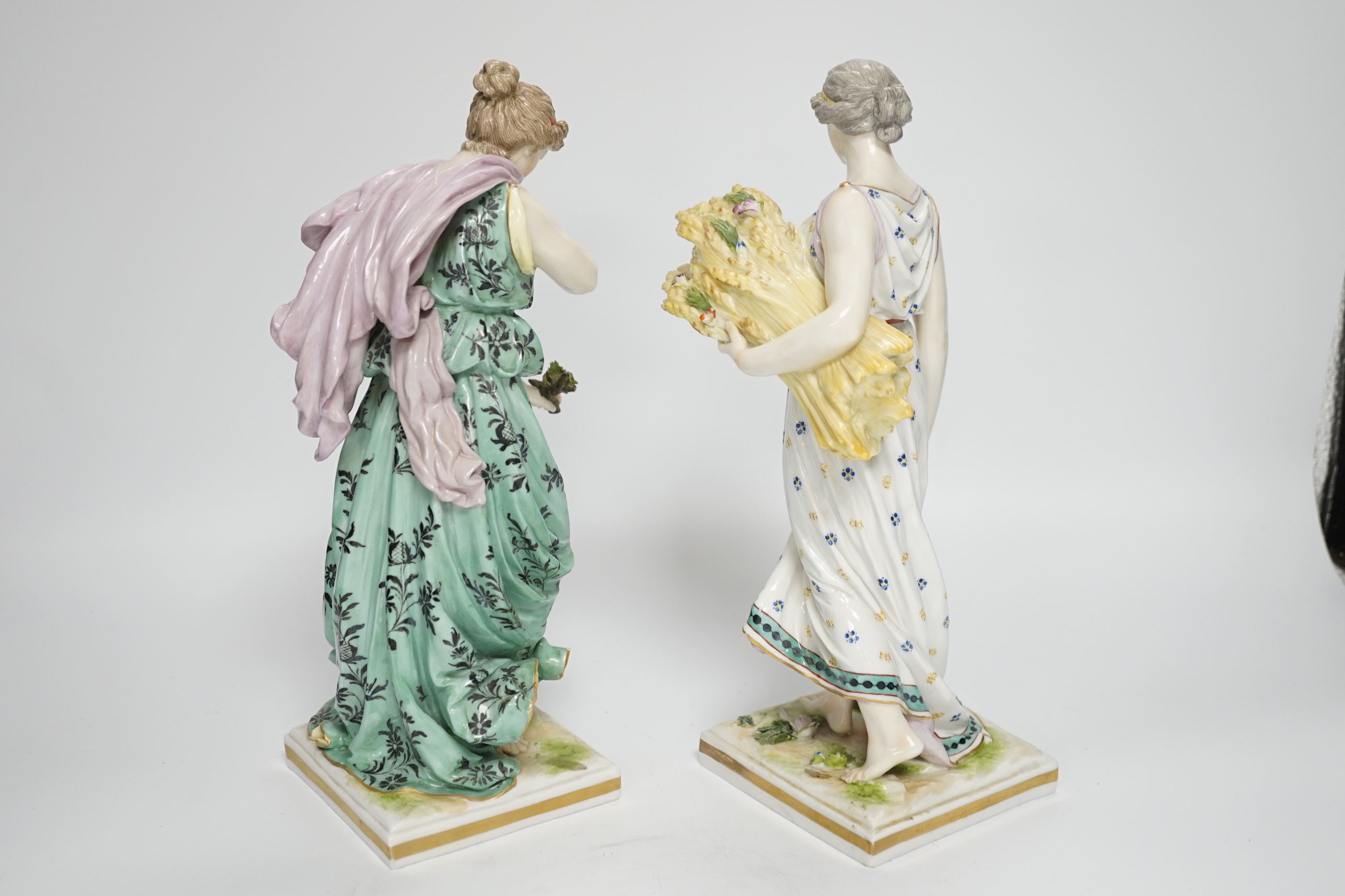 A pair of Frankenthal style porcelain female figures emblematic of summer and winter, 27.5cm